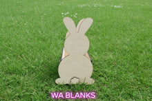 Load image into Gallery viewer, Wooden rabbit-shaped holder on a wooden surface with a textured wall in the background